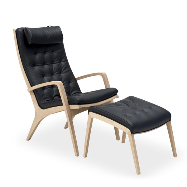 Billede af Lænestol SA-LUX med høj ryg og armlæn. Stolen kan polstres i flere typer tekstil, inkl. kunstlæder, fås også med gjorde-flet og træksyninger.